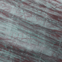“Grassland granite slab with green base and dramatic red veining from Nujum Al-Rukham in Saudi Arabia.”