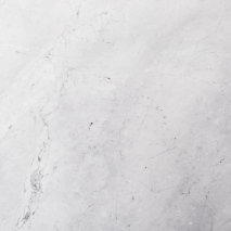 “Aqua Bianco marble slab with soft white surface and light grey veining from Nujum Al-Rukham in Saudi Arabia.”