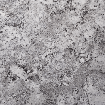 “Snow White Mountain granite slab with white base and grey mineral texture from Nujum Al-Rukham in Saudi Arabia.”