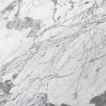 “Statuarietto marble slab with white base and dynamic grey veining from Nujum Al-Rukham in Saudi Arabia.”