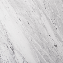 “Statuario marble slab with white base and defined grey veining from Nujum Al-Rukham in Saudi Arabia.”