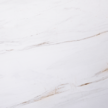 “Thassos Gold marble slab with pure white base and soft golden linear accents from Nujum Al-Rukham in Saudi Arabia.”