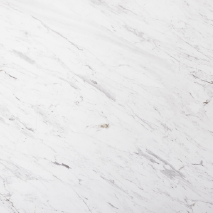 “Volakas marble slab with white base and soft grey linear veining from Nujum Al-Rukham in Saudi Arabia.”