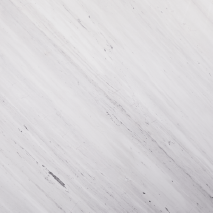 “White Plant marble slab with bright white base and soft diagonal grey veining from Nujum Al-Rukham in Saudi Arabia.”